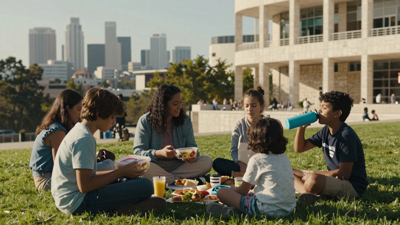 Families picnicking on a museum lawn with the city skyline in the background, enjoying food outside galleries.